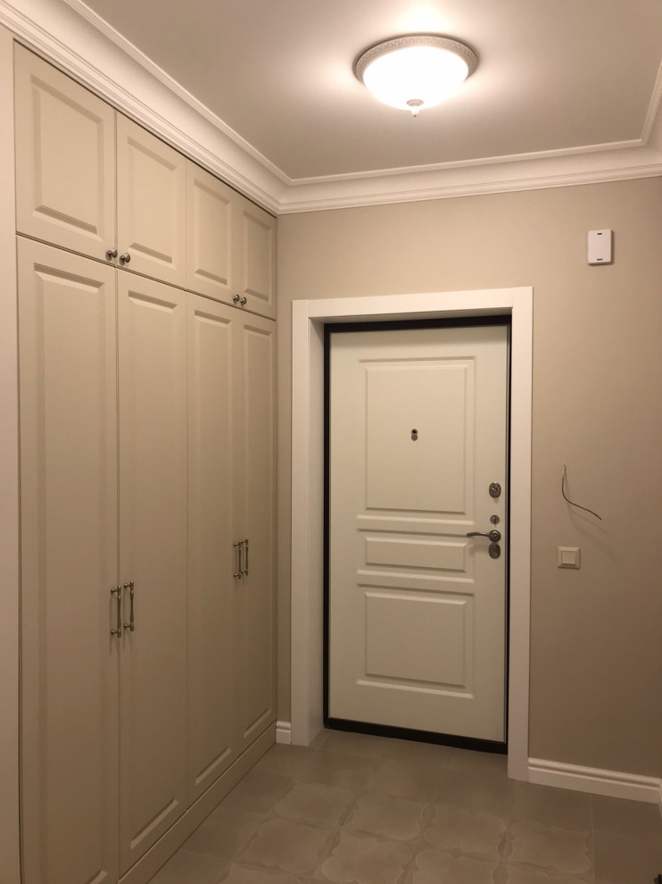 This is an example of a medium sized classic front door in Other with beige walls, porcelain flooring, a single front door, a light wood front door and beige floors.