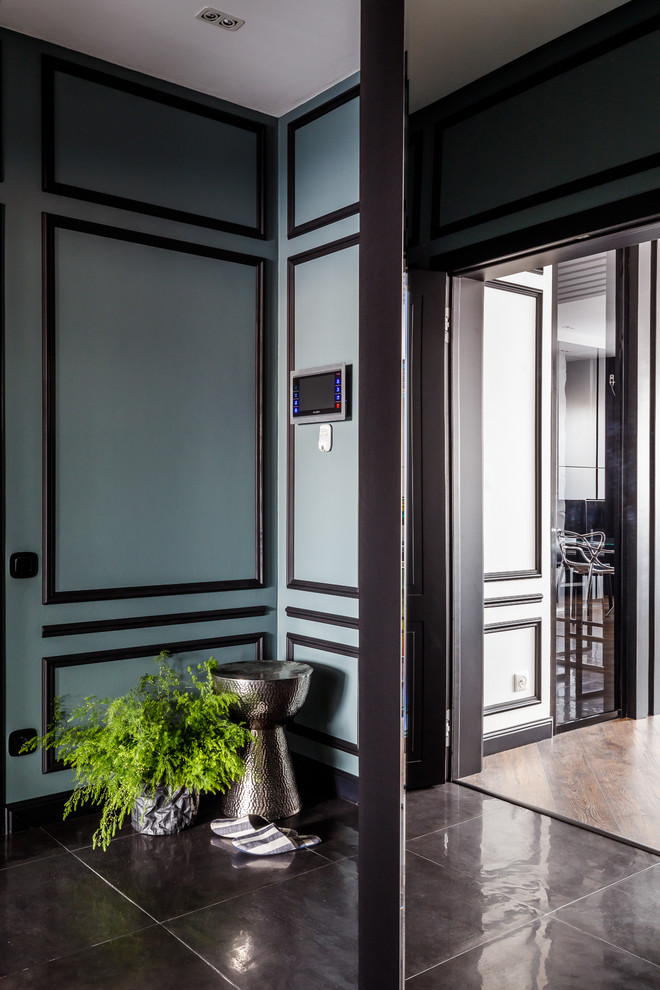 他の地域にある高級な中くらいなコンテンポラリースタイルのおしゃれな玄関 (緑の壁、磁器タイルの床、黒い床) の写真