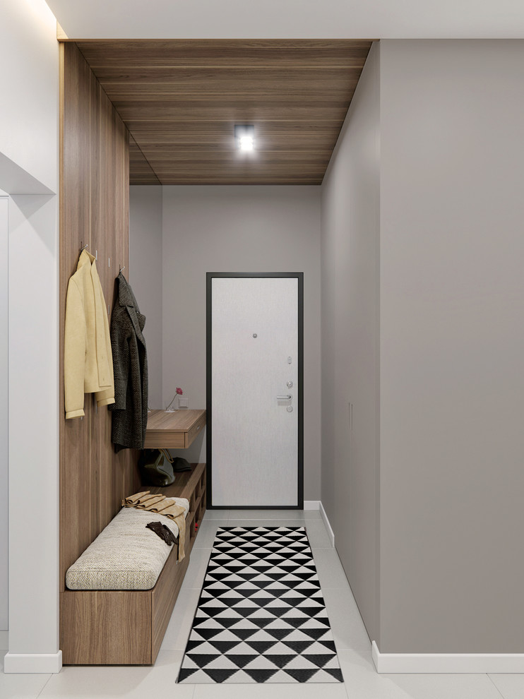 Foto di un corridoio design di medie dimensioni con pareti grigie, pavimento in gres porcellanato e pavimento grigio