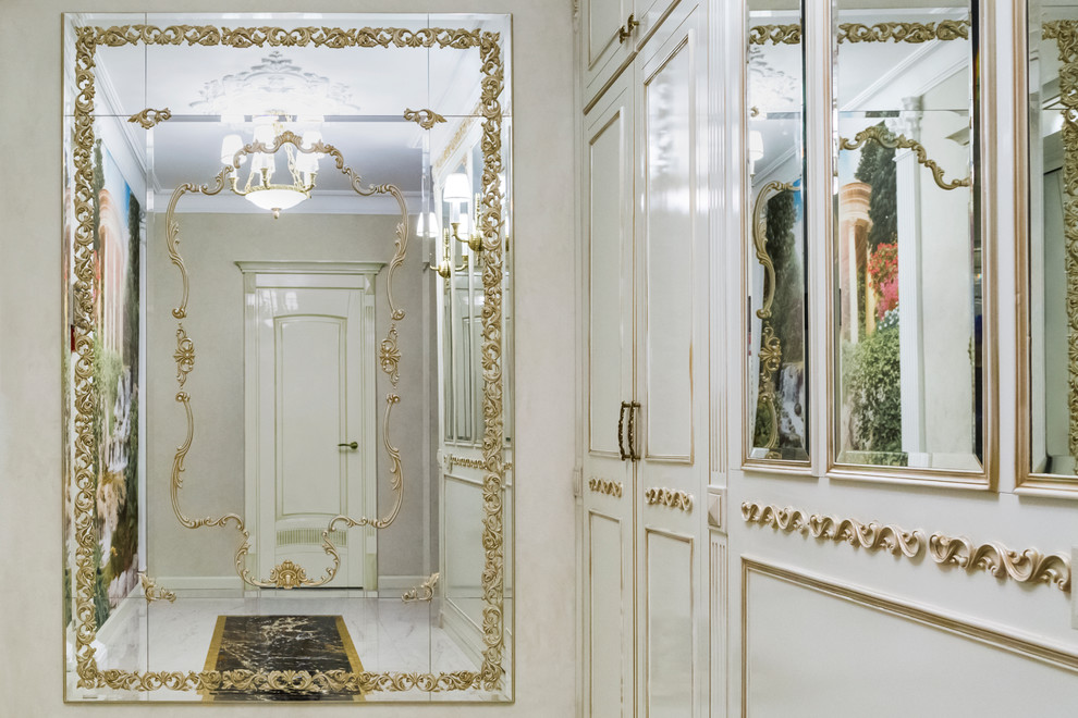 Example of a mid-sized classic marble floor and white floor entryway design in Moscow with white walls and a white front door