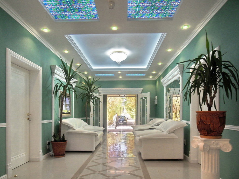 他の地域にあるお手頃価格の中くらいなトラディショナルスタイルのおしゃれな玄関ロビー (緑の壁、磁器タイルの床、ガラスドア、ベージュの床) の写真