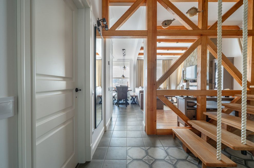This is an example of a medium sized mediterranean entrance in Other with white walls, porcelain flooring and grey floors.