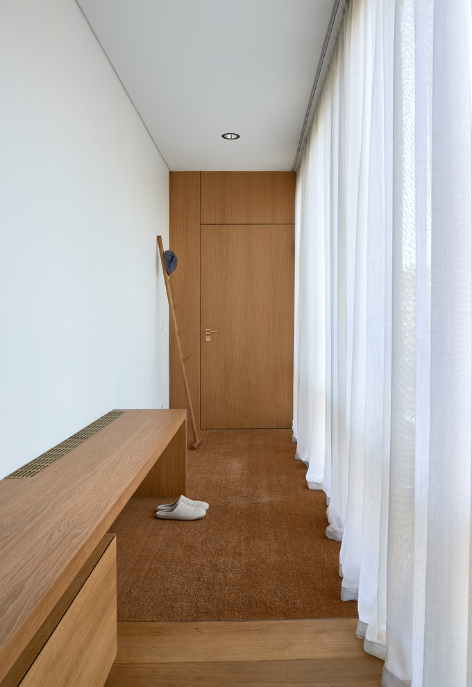 Entryway - mid-sized contemporary beige floor entryway idea in Other