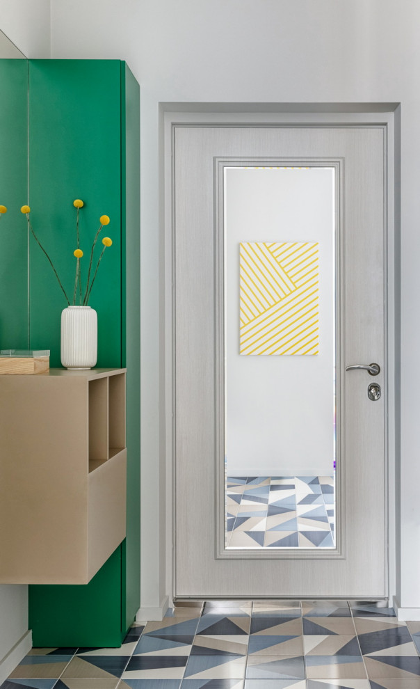 Modelo de hall escandinavo de tamaño medio con paredes grises, suelo de baldosas de cerámica, puerta simple, puerta de madera clara y suelo azul