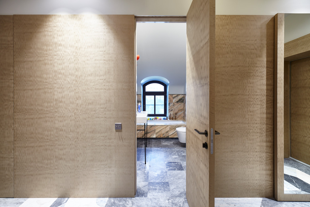 This is an example of a medium sized contemporary entrance in Moscow with beige walls and wainscoting.