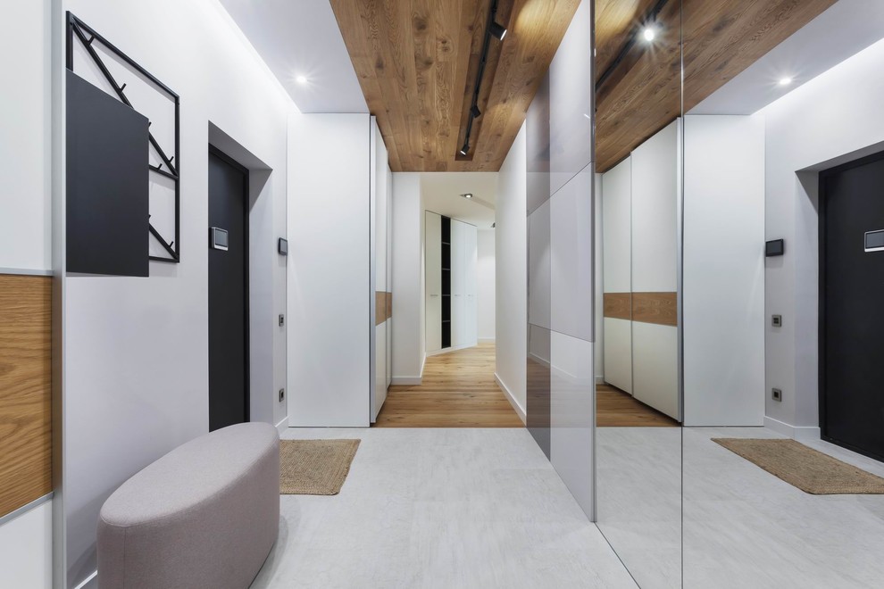 Medium sized contemporary front door in Yekaterinburg with white walls, porcelain flooring, a single front door, a black front door and grey floors.