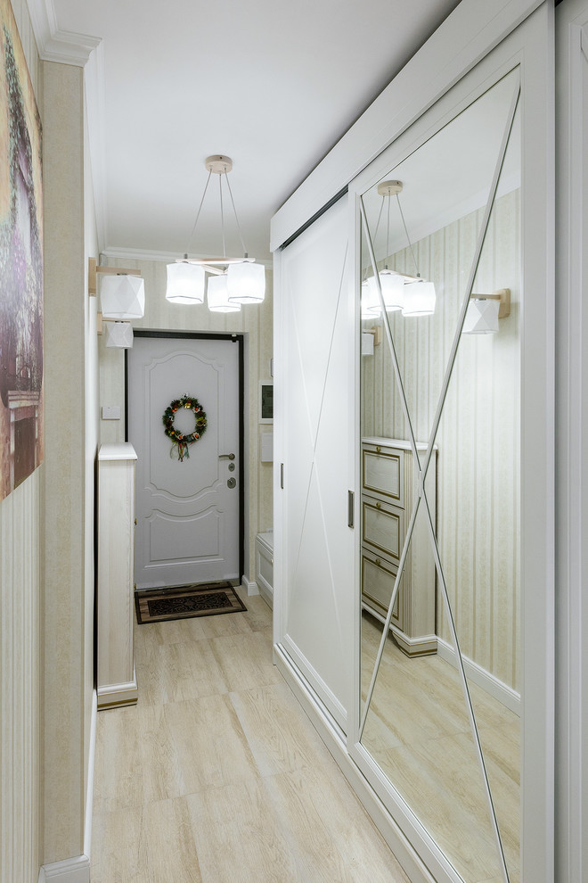 Ispirazione per un piccolo corridoio tradizionale con pareti gialle, pavimento in laminato, una porta a due ante, una porta bianca e pavimento beige