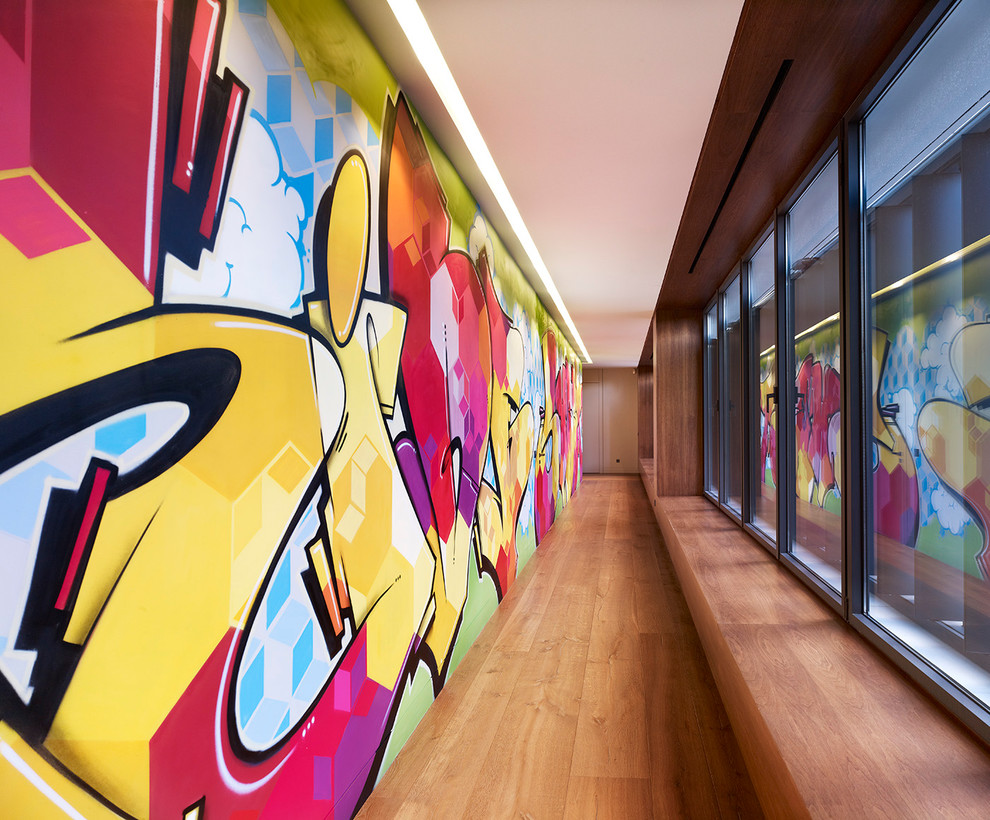 Large minimalist medium tone wood floor and brown floor hallway photo in Madrid with multicolored walls