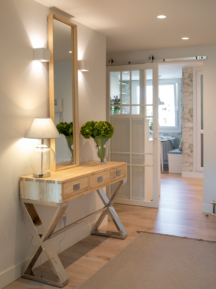 Hallway - transitional laminate floor and brown floor hallway idea in Other with white walls