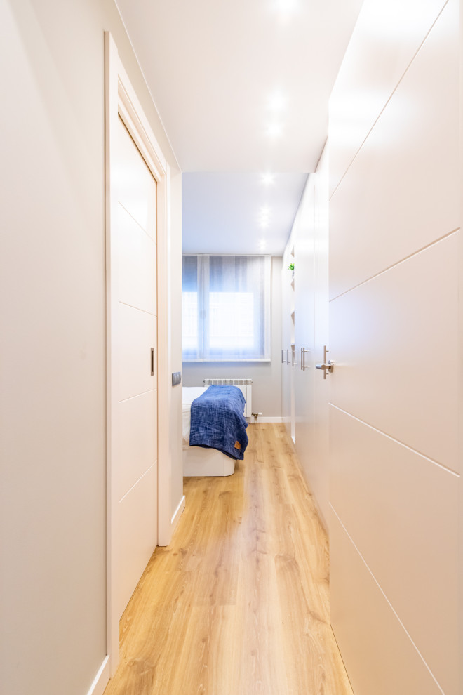 Inspiration for a mid-sized contemporary laminate floor hallway remodel in Barcelona with beige walls