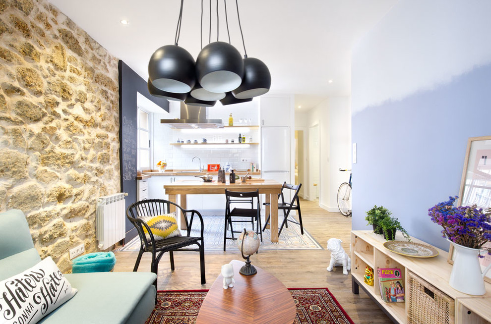 Medium sized classic open plan games room in Madrid with multi-coloured walls, medium hardwood flooring, no fireplace and no tv.