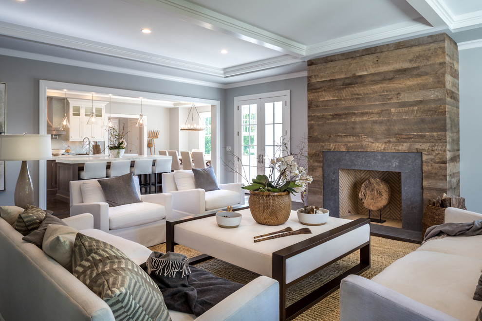 Inspiration for a transitional carpeted family room remodel in New York with gray walls, a standard fireplace and no tv
