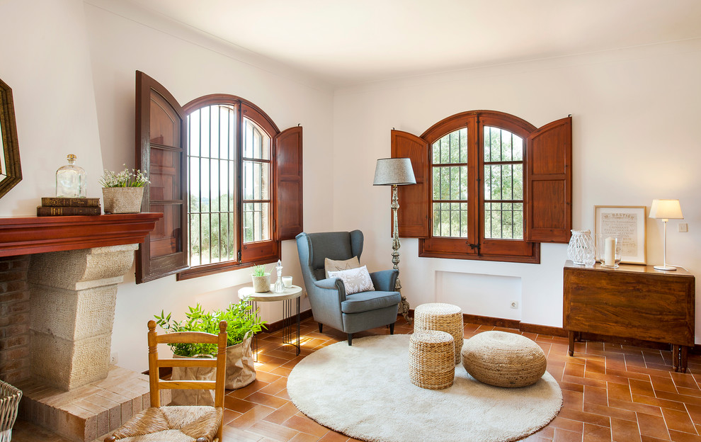 This is an example of a small rustic open plan games room in Barcelona with white walls.