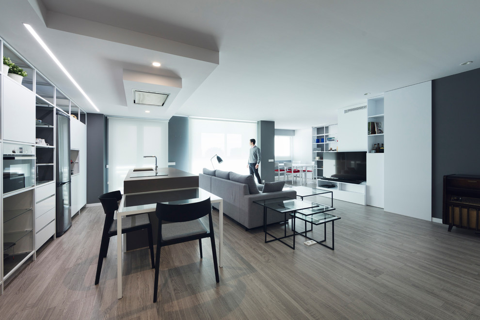Foto di un piccolo soggiorno design aperto con pareti bianche, pavimento in legno massello medio e TV autoportante