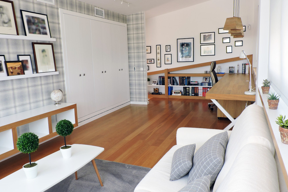 Family room - mid-sized scandinavian medium tone wood floor family room idea in Valencia with white walls