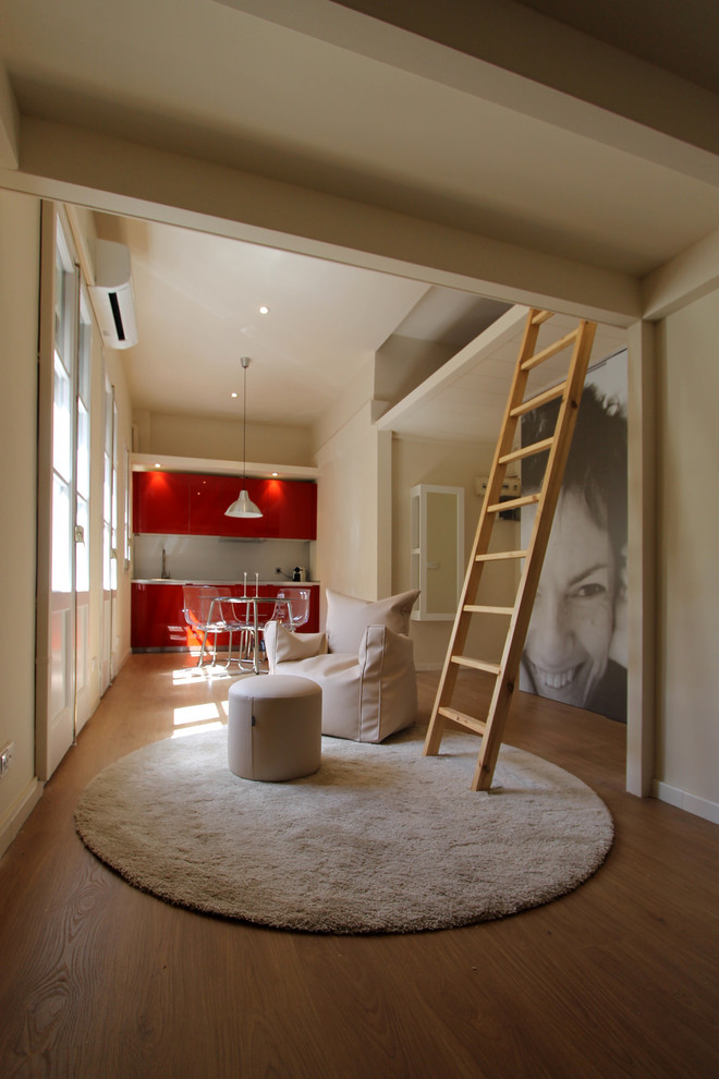 Foto de sala de estar abierta contemporánea pequeña sin chimenea y televisor con paredes beige y suelo de madera en tonos medios