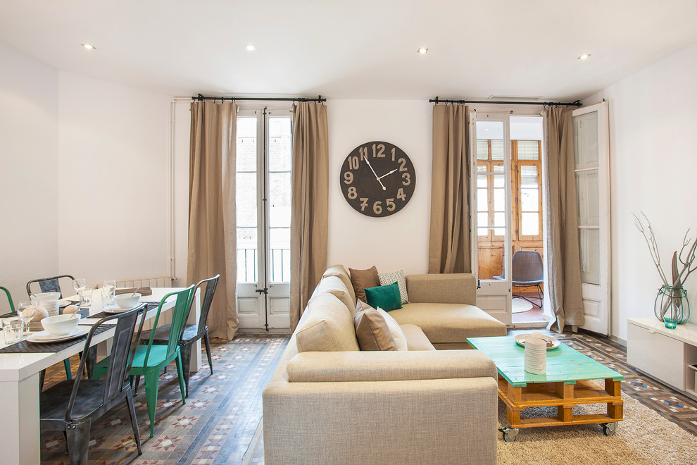 Large mediterranean open plan games room in Barcelona with white walls, no fireplace, ceramic flooring and no tv.