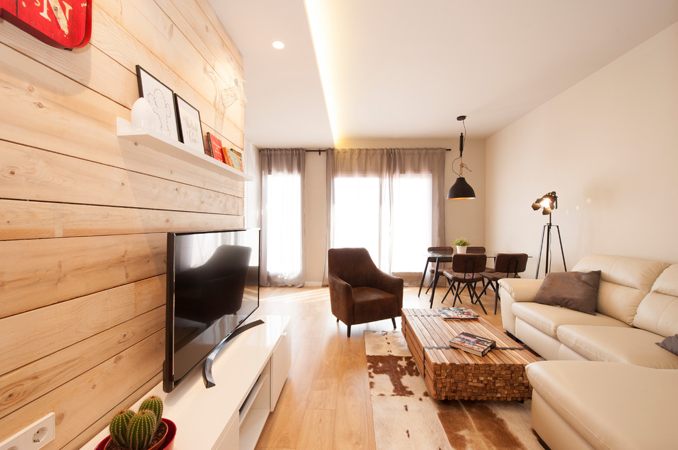 Diseño de sala de estar abierta actual de tamaño medio con paredes grises, suelo de madera clara, televisor independiente y suelo marrón