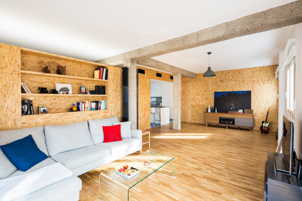 Foto di un grande soggiorno industriale aperto con pavimento in legno massello medio, nessun camino, TV autoportante e pareti marroni
