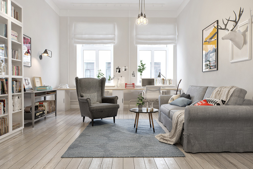 Diseño de sala de estar con biblioteca escandinava de tamaño medio sin televisor y chimenea con paredes blancas y suelo de madera en tonos medios