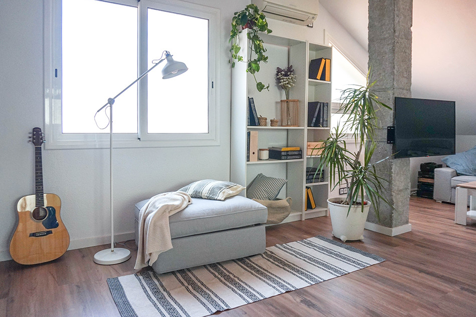 Inspiration for a medium sized urban mezzanine games room in Barcelona with white walls, laminate floors, no fireplace, a corner tv and brown floors.
