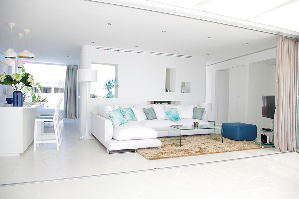 Mittelgroßes, Offenes Maritimes Wohnzimmer mit weißer Wandfarbe und freistehendem TV in Sonstige