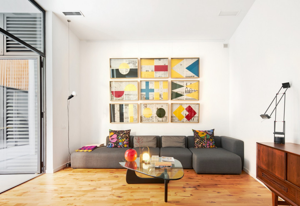 Ejemplo de sala de estar contemporánea con paredes blancas, suelo de madera en tonos medios y suelo marrón