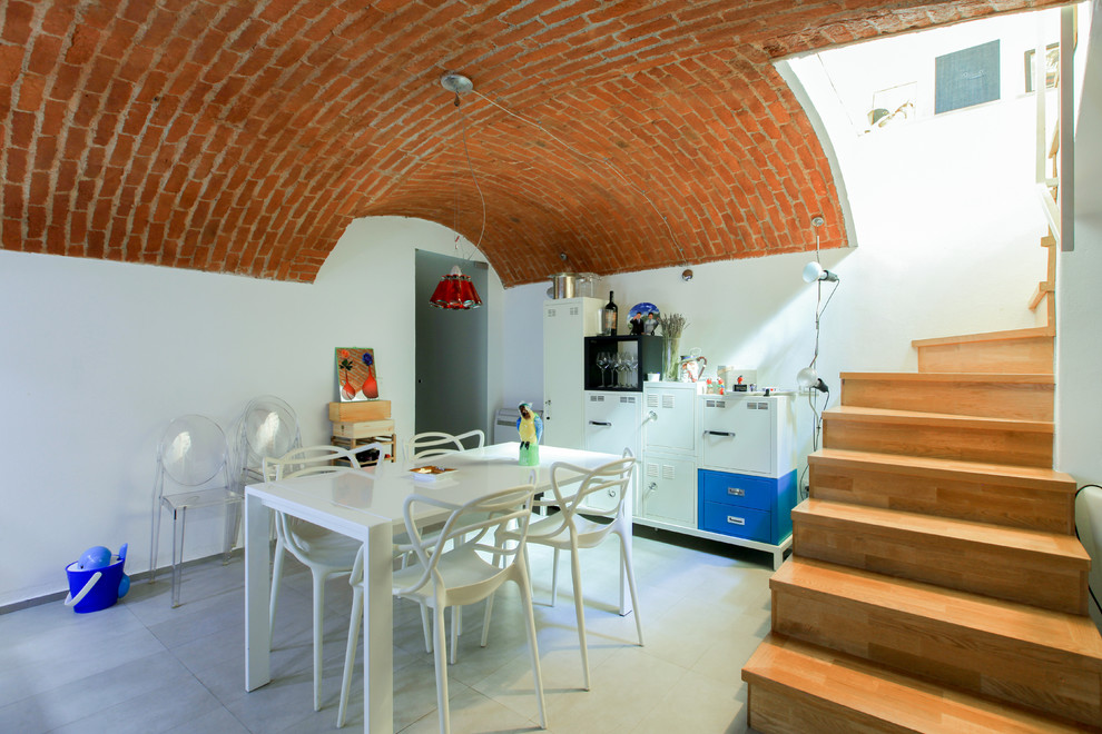 Immagine di una sala da pranzo aperta verso il soggiorno mediterranea di medie dimensioni con pareti bianche