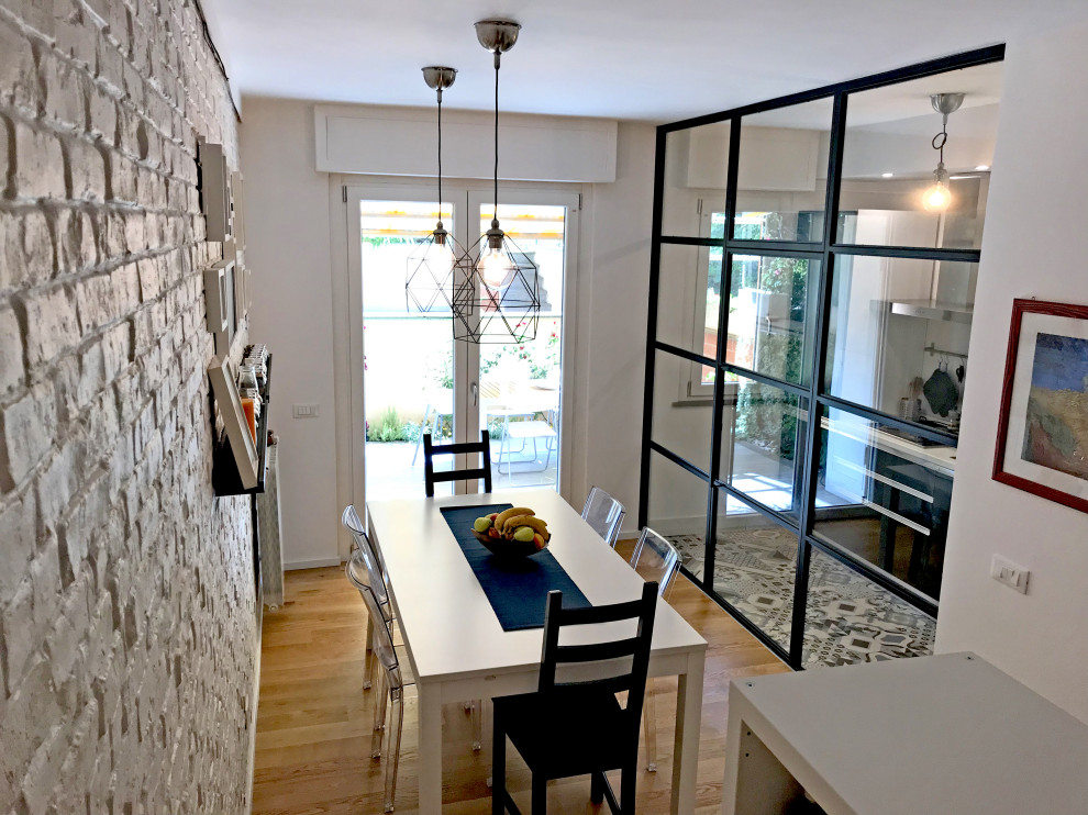 Photo of a medium sized scandinavian open plan dining room with white walls, light hardwood flooring and beige floors.