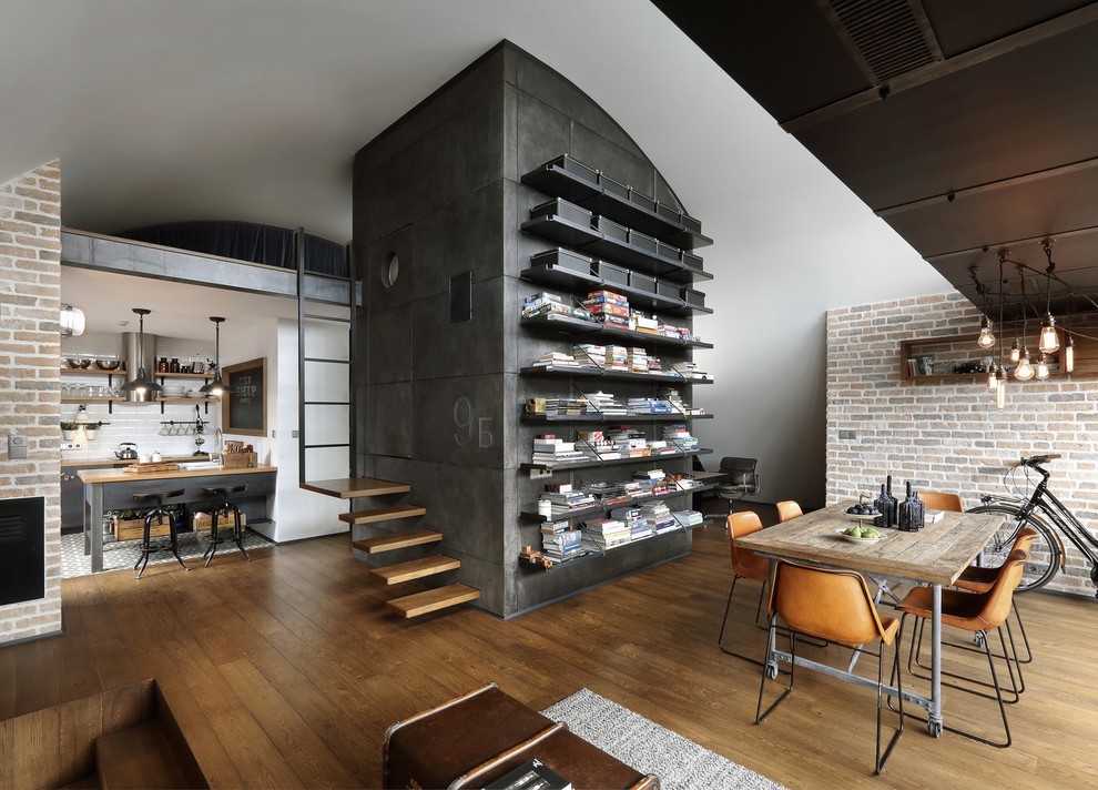 Inspiration for an industrial dining room in Naples with white walls and medium hardwood flooring.