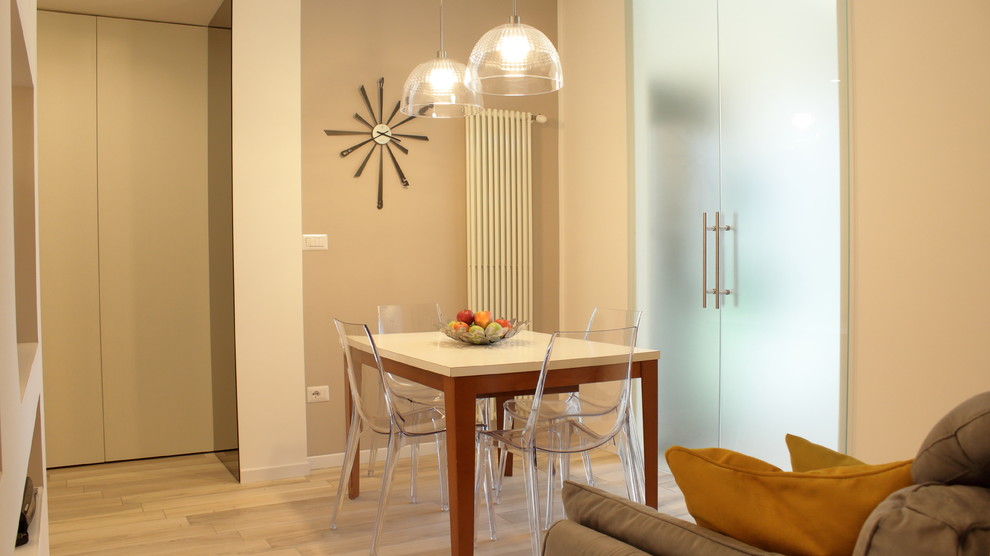 Ispirazione per una piccola sala da pranzo aperta verso la cucina design con pareti beige e pavimento in gres porcellanato