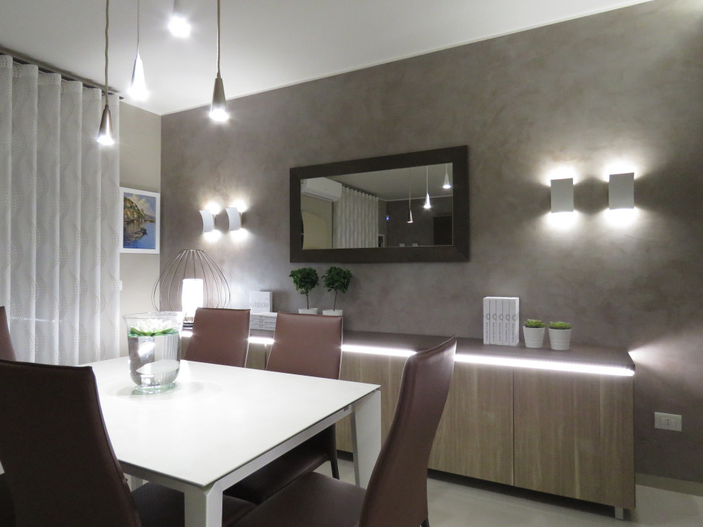This is an example of a medium sized contemporary open plan dining room in Catania-Palermo with multi-coloured walls, porcelain flooring and beige floors.