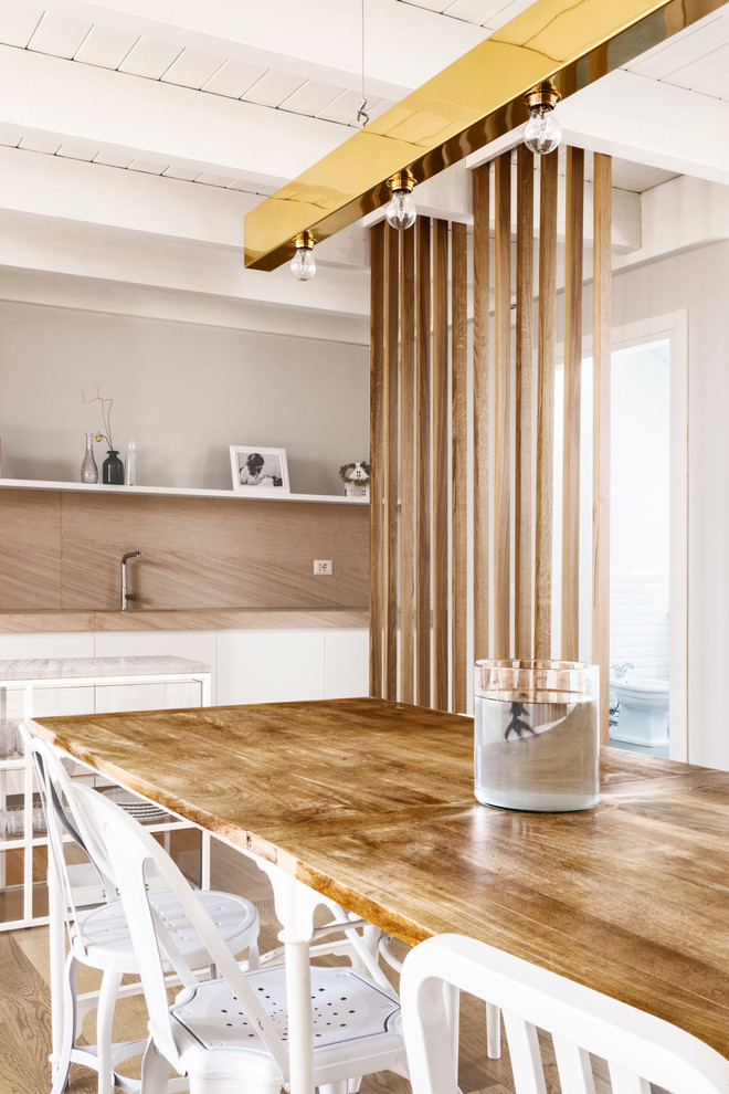 This is an example of a contemporary kitchen/dining room in Milan with dark hardwood flooring.