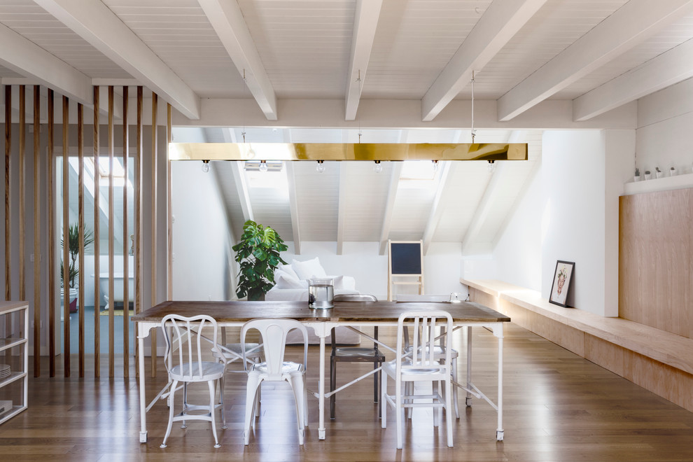 This is an example of a contemporary open plan dining room in Milan with white walls and dark hardwood flooring.