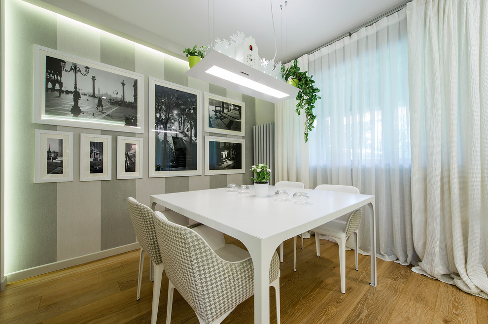 Foto di una sala da pranzo aperta verso il soggiorno minimal di medie dimensioni con pareti multicolore e parquet chiaro