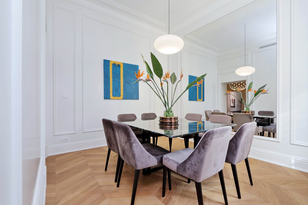 Design ideas for a classic dining room in Rome with light hardwood flooring and wainscoting.