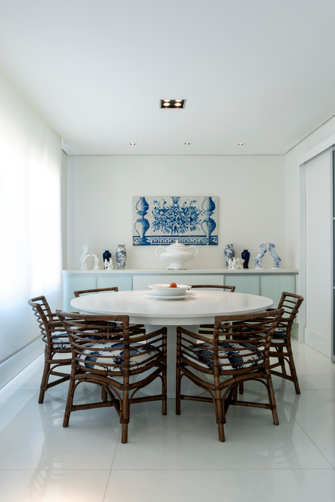 Photo of a world-inspired dining room in Other with white walls and white floors.