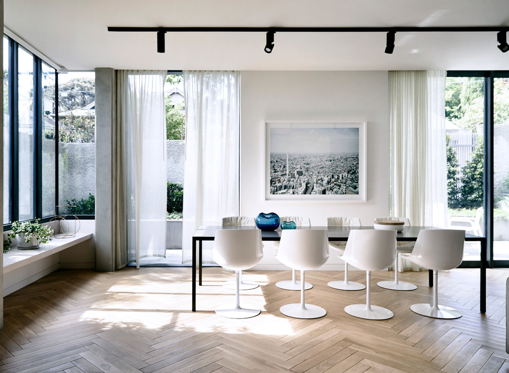 Photo of a large modern dining room in Milan with white walls.