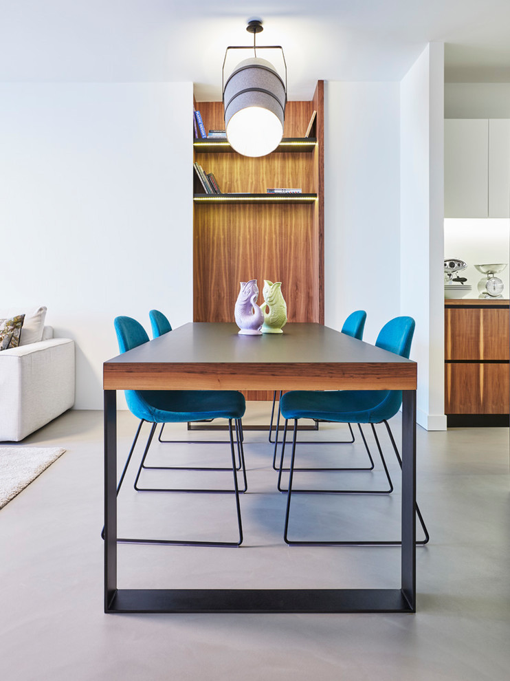 Mid-sized trendy concrete floor and gray floor dining room photo in Turin with white walls and no fireplace