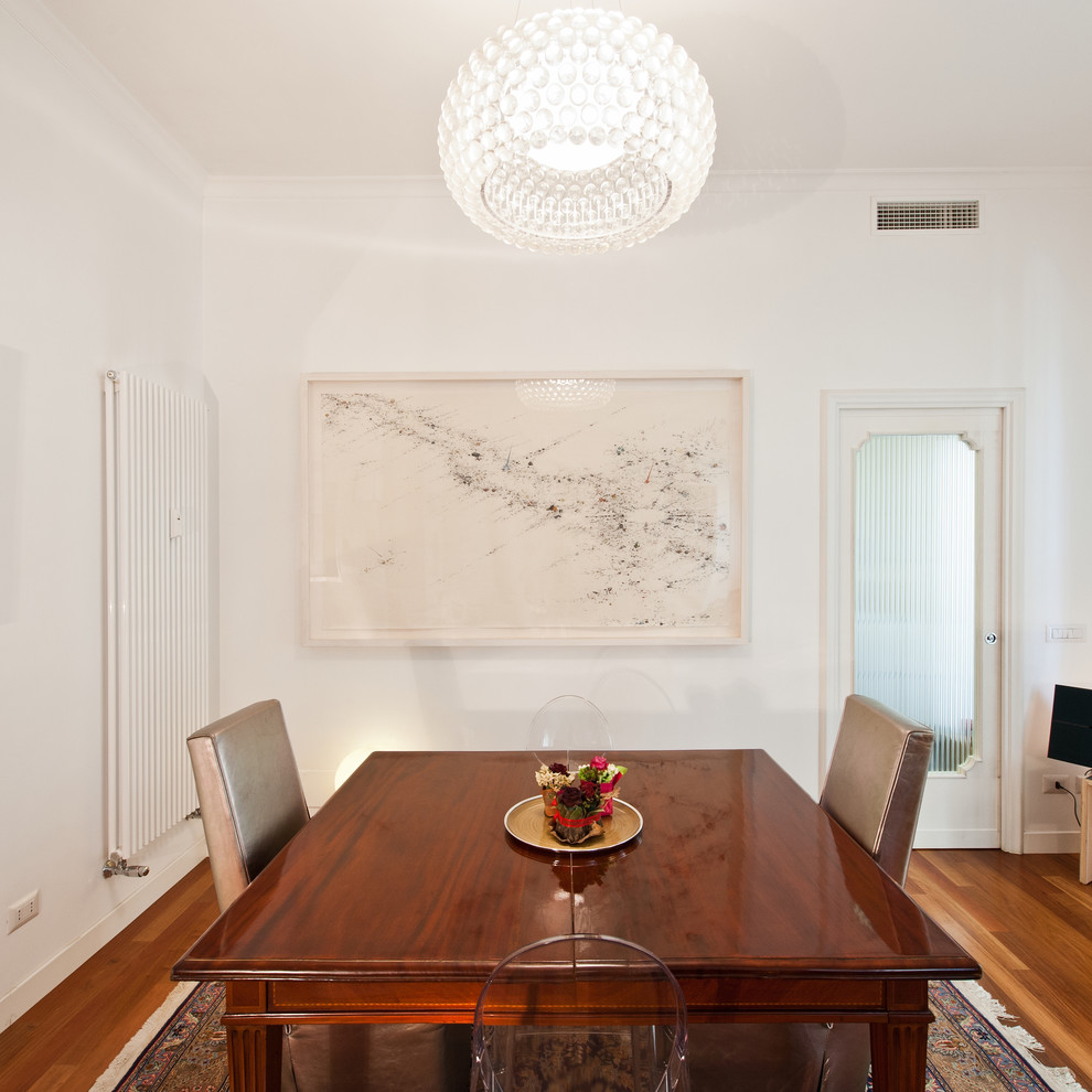 Foto di una sala da pranzo minimal con pareti bianche e parquet scuro