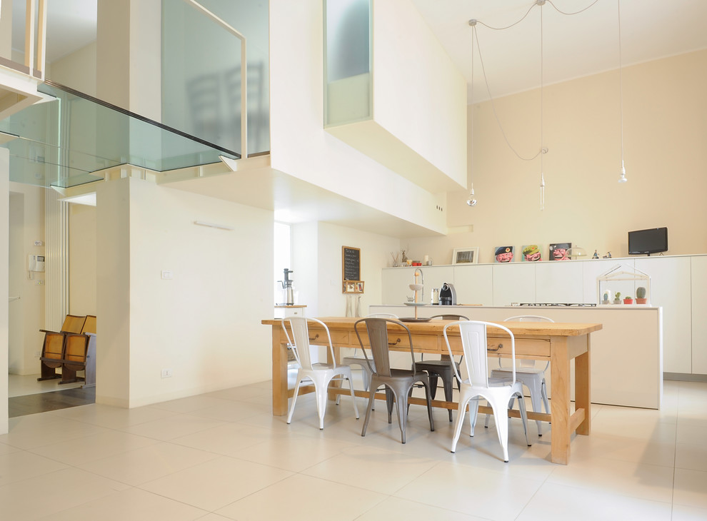 Photo of a medium sized contemporary open plan dining room in Turin with white walls.