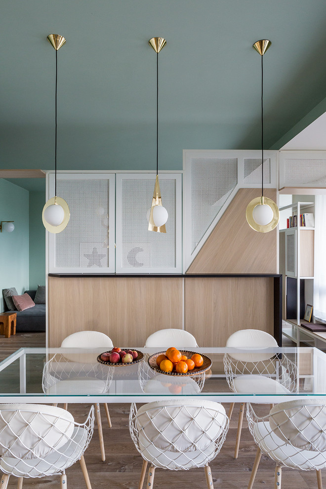 Immagine di una sala da pranzo design con pareti verdi, pavimento in legno massello medio e pavimento marrone