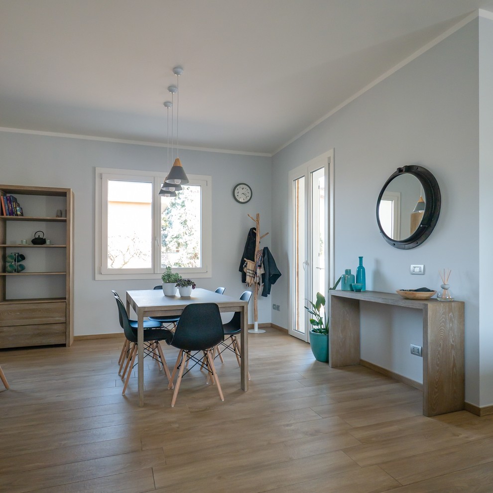 Inspiration for a medium sized scandinavian open plan dining room in Milan with porcelain flooring and beige floors.