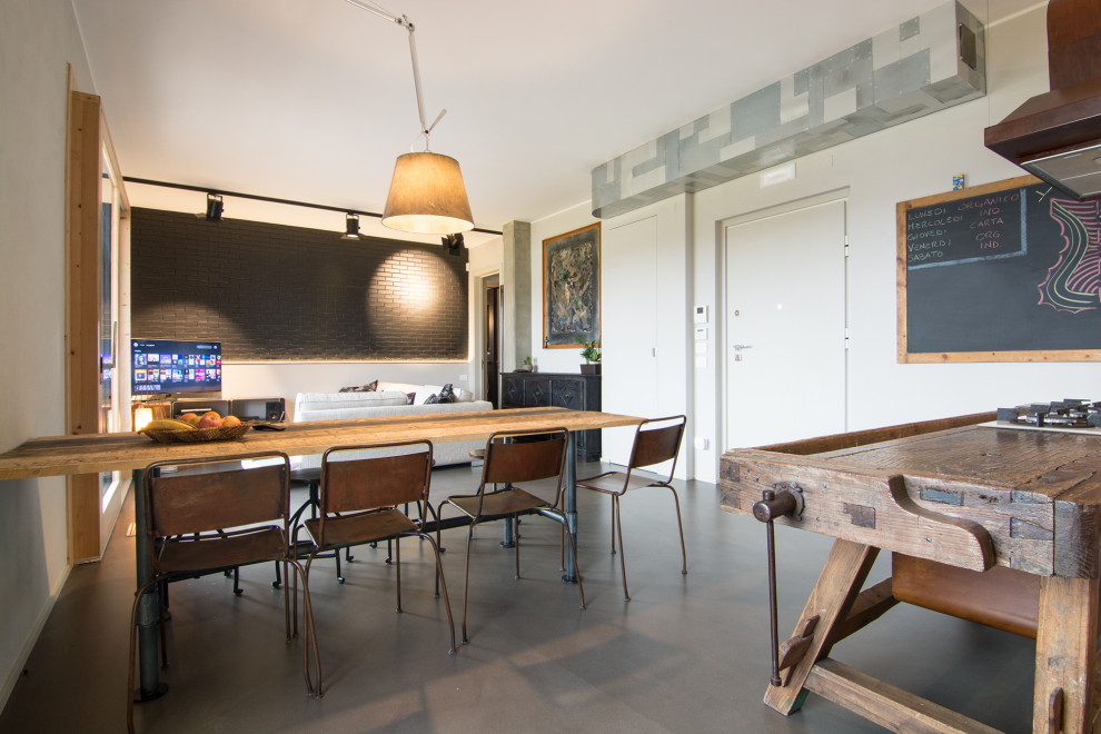 Mid-sized urban concrete floor and gray floor great room photo in Florence with gray walls