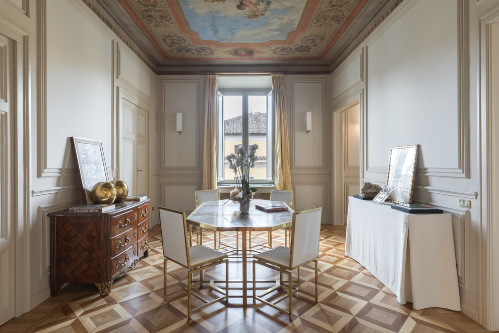 Classic enclosed dining room in Rome with white walls, medium hardwood flooring and brown floors.