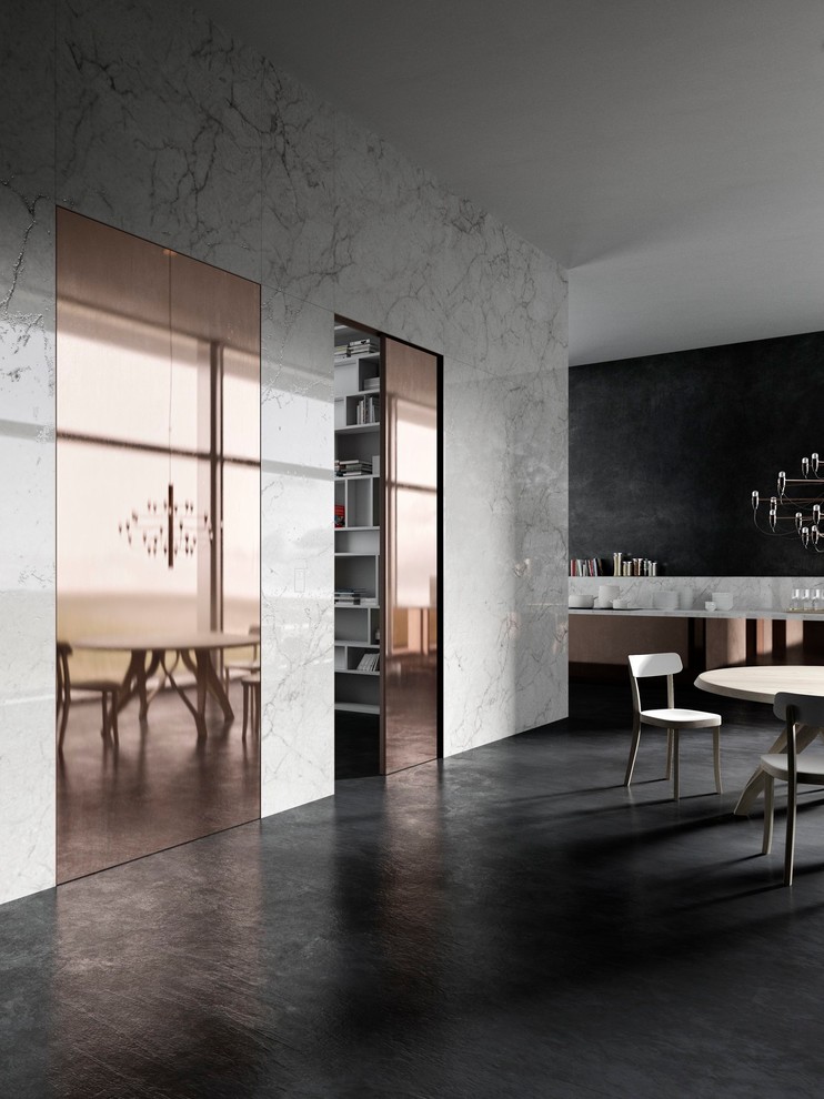 Idee per una grande sala da pranzo aperta verso il soggiorno design con pareti bianche e pavimento nero
