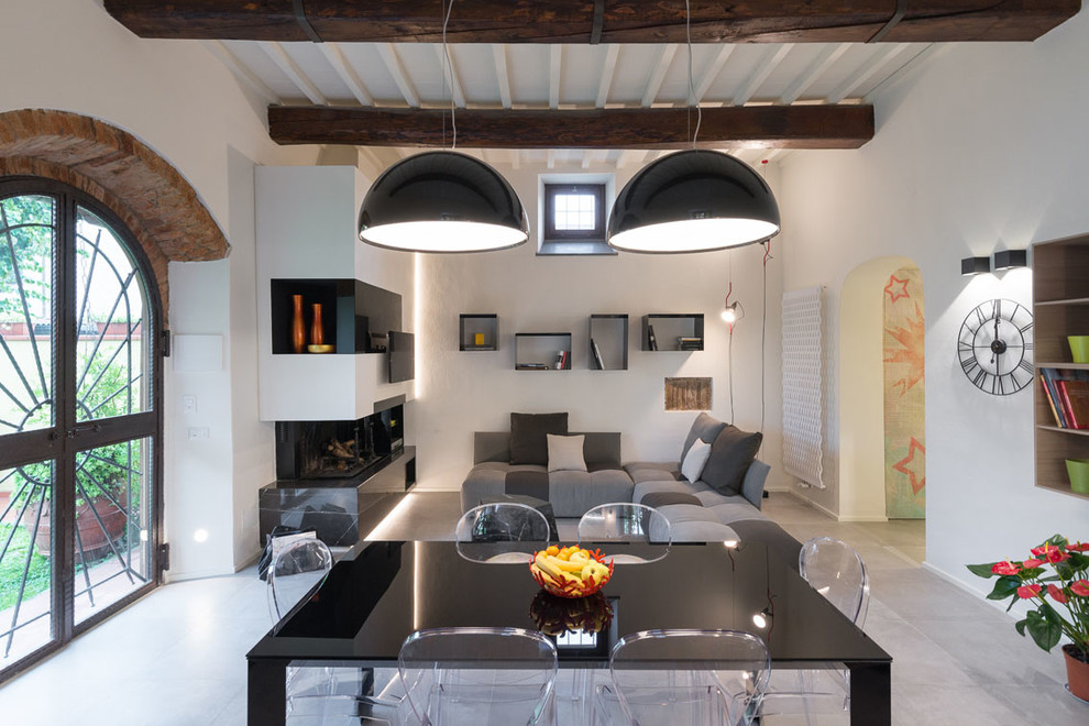 This is an example of a contemporary dining room in Florence with a ribbon fireplace.