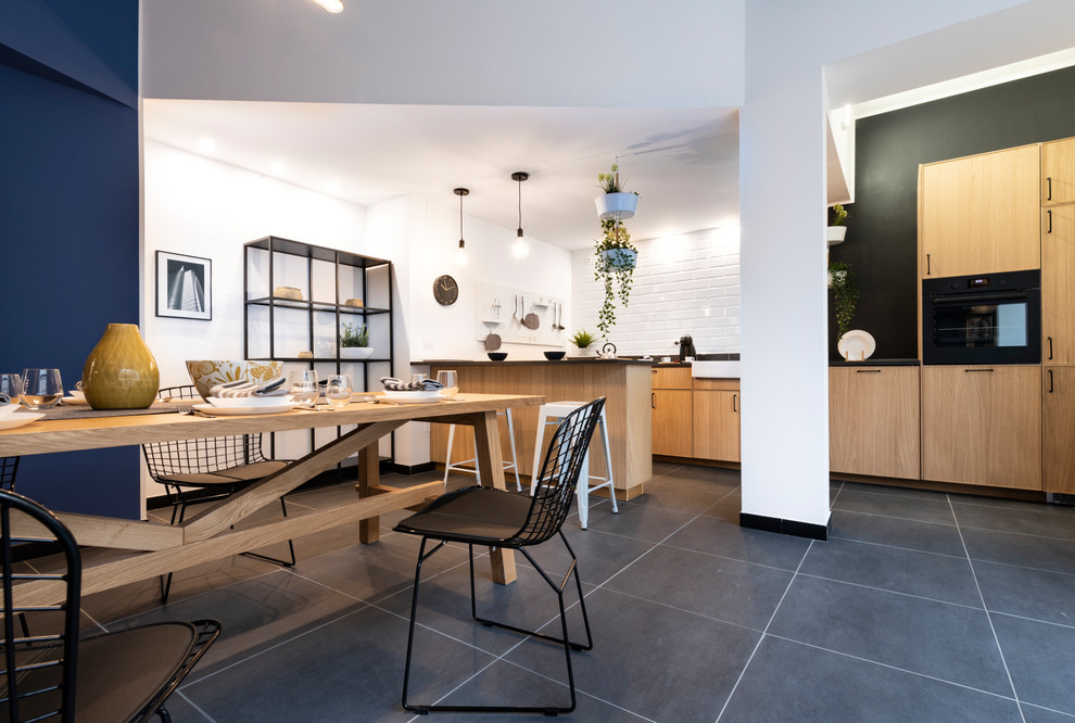Inspiration for an urban open plan dining room in Milan with white walls and grey floors.
