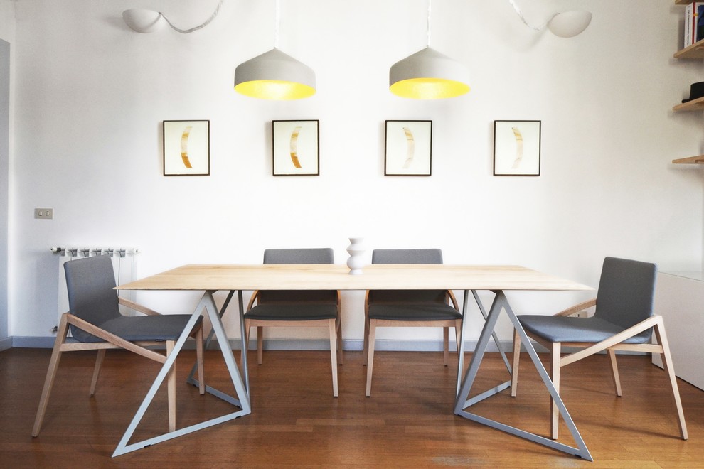 Immagine di una sala da pranzo nordica con pareti bianche e pavimento in legno massello medio