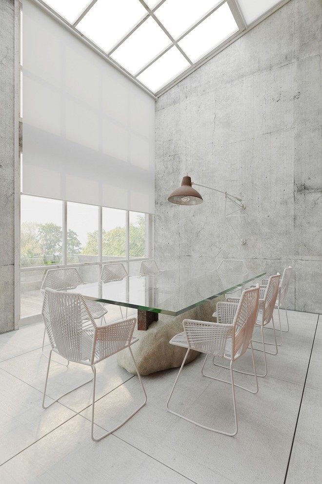 Foto di una sala da pranzo aperta verso il soggiorno contemporanea con pareti grigie